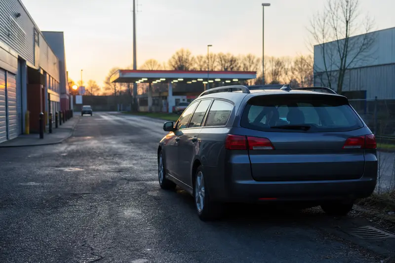 A company car parked on an industrial estate at dawn